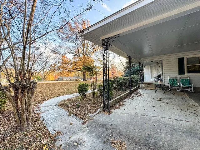 a view of a dirt road and a building