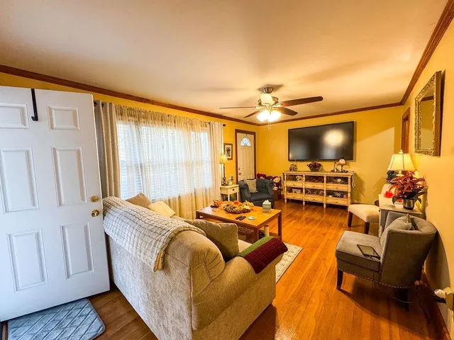 a living room with furniture and a flat screen tv