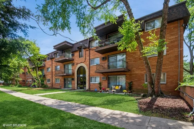 a front view of a house with a garden and plants