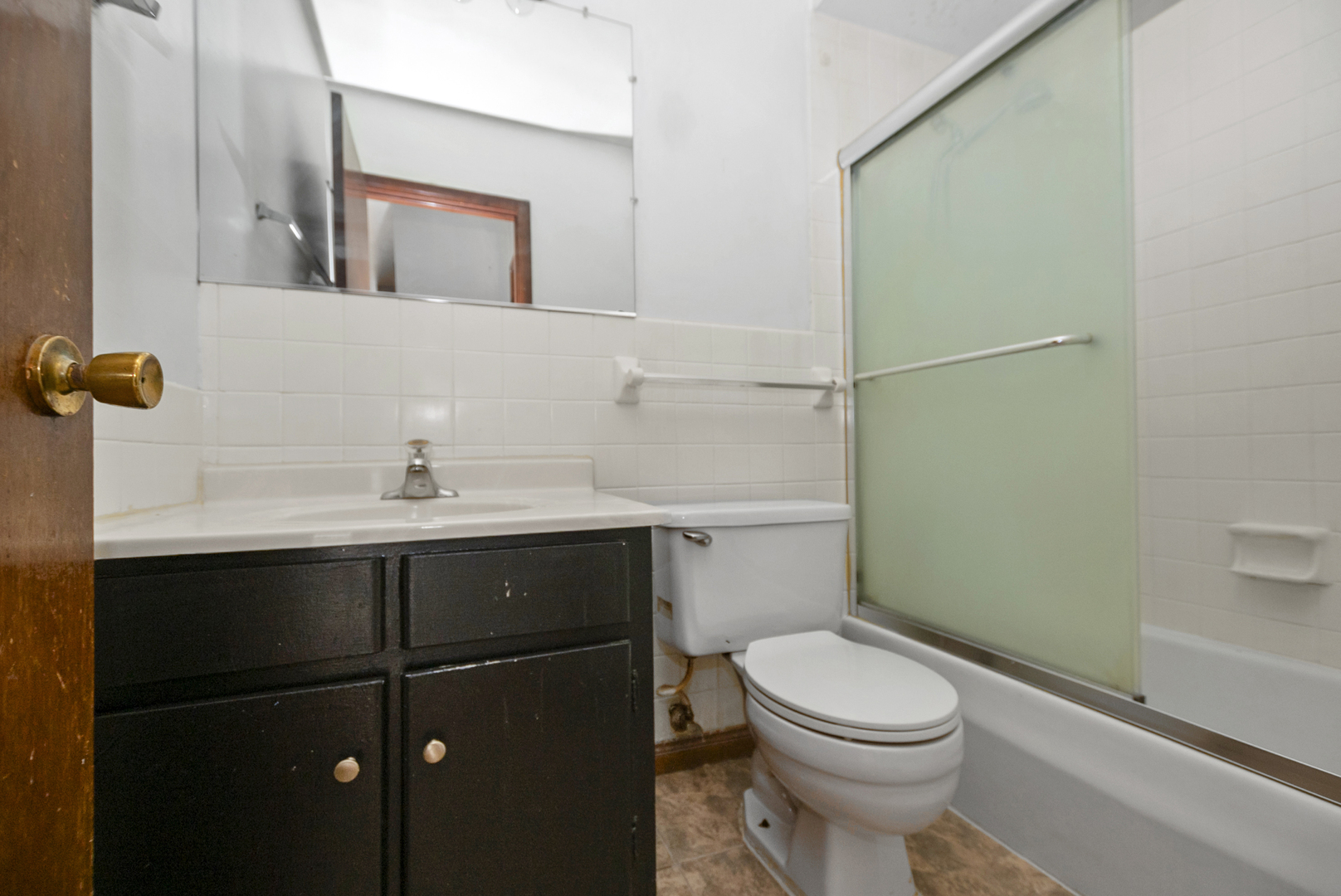 2340 186th Street, Unit 28 Lansing, IL 60438 - Photo 11 of 14 a bathroom with a sink a toilet and shower