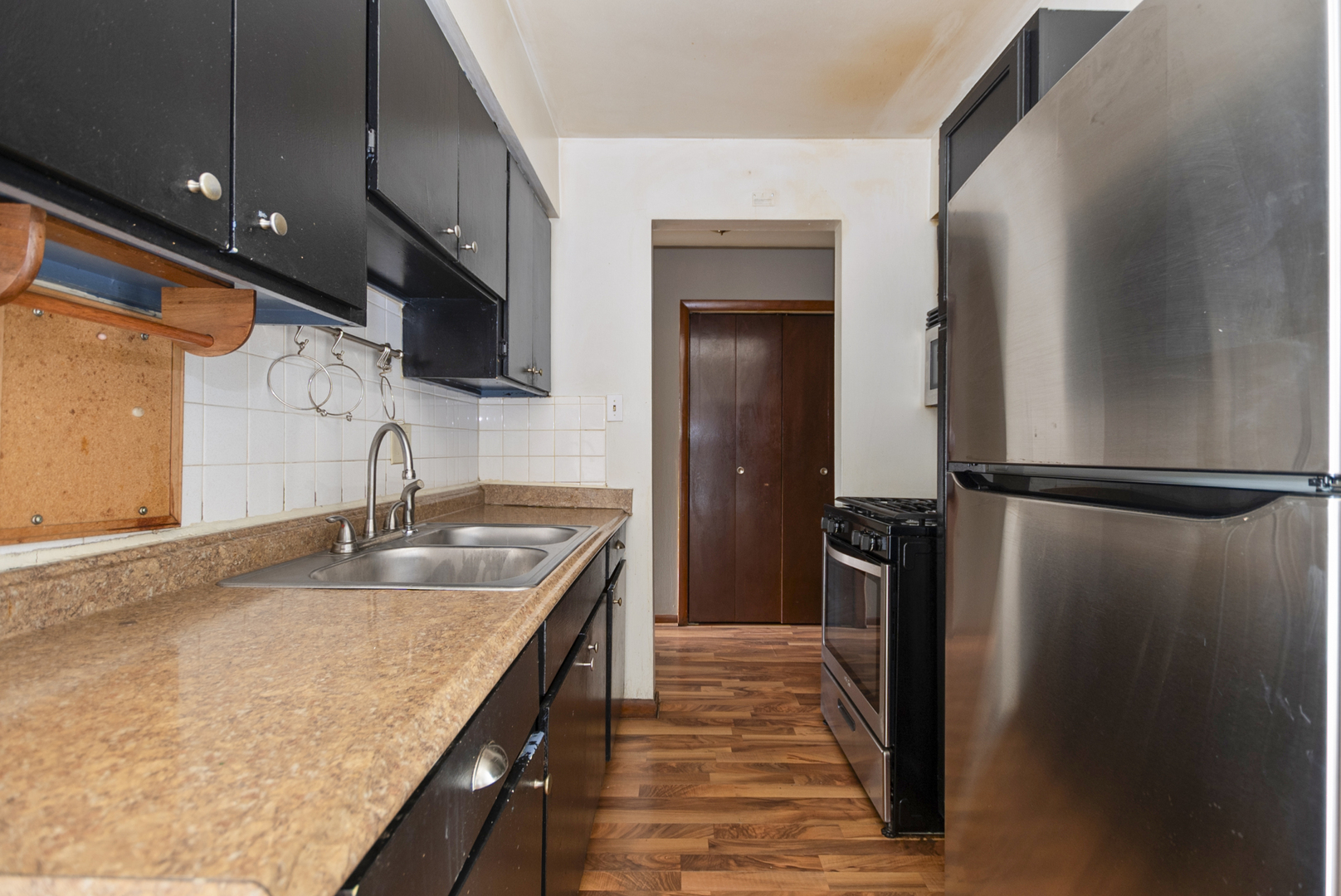 2340 186th Street, Unit 28 Lansing, IL 60438 - Photo 5 of 14 a kitchen with stainless steel appliances granite countertop a sink and a refrigerator