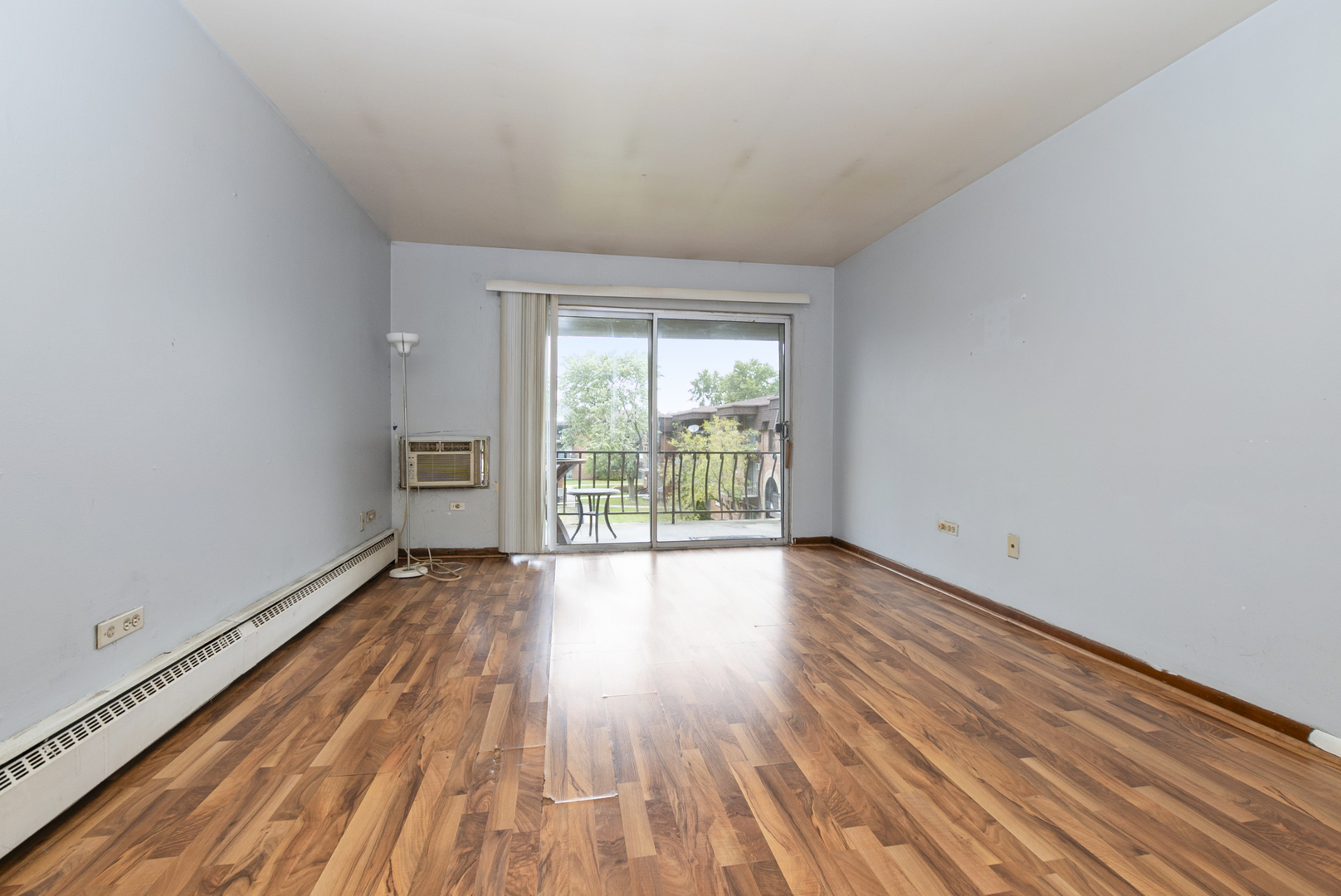 2340 186th Street, Unit 28 Lansing, IL 60438 - Photo 8 of 14 a view of an empty room with wooden floor and a window