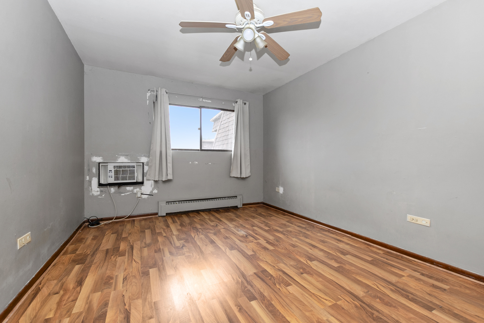 2340 186th Street, Unit 28 Lansing, IL 60438 - Photo 9 of 14 a view of empty room with wooden floor and fan