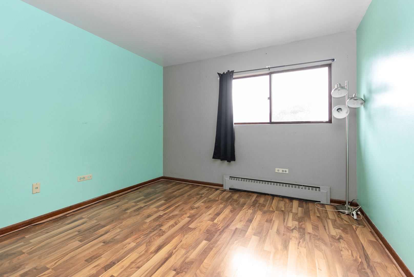 2340 186th Street, Unit 28 Lansing, IL 60438 - Photo 10 of 14 an empty room with wooden floor and windows