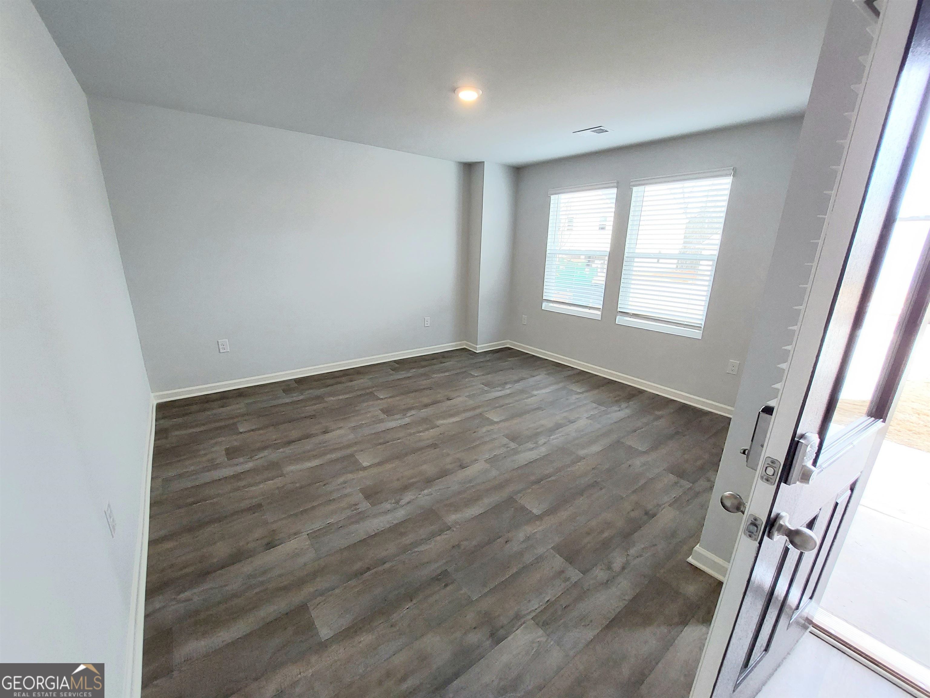 503 Holsteiner Road, Unit 67 Hogansville, GA 30230 - Photo 3 of 15 a view of an empty room with wooden floor and a window
