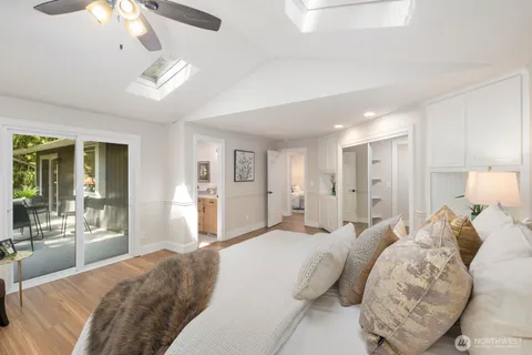 a spacious bedroom with a bed and ceiling fan