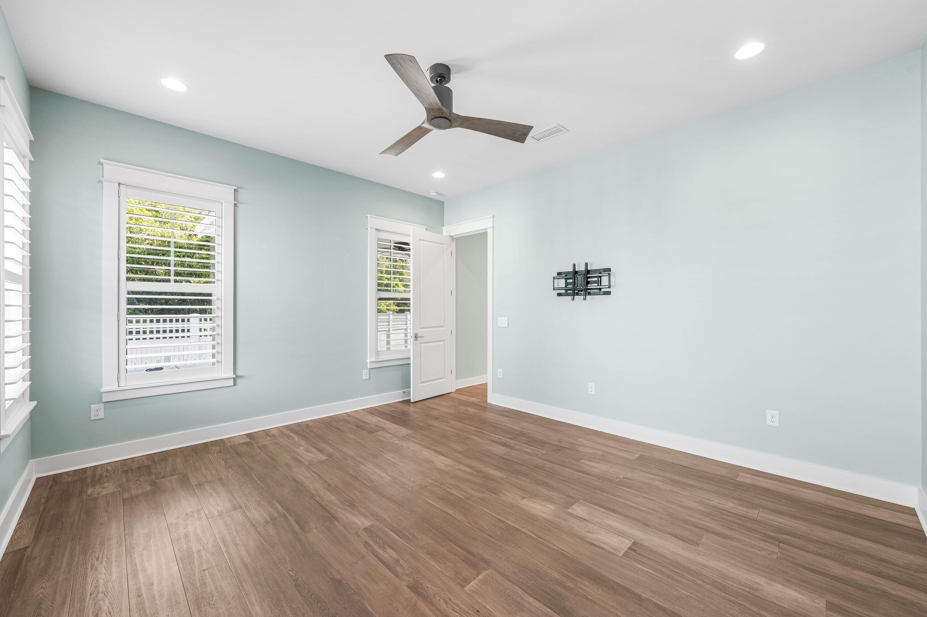 234 Sidecamp Rd Inlet Beach Inlet Beach, FL 32461 - Photo 23 of 57 an empty room with wooden floor ceiling fan and windows