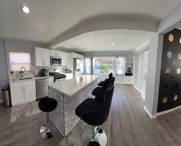 a large kitchen with lots of counter space and windows