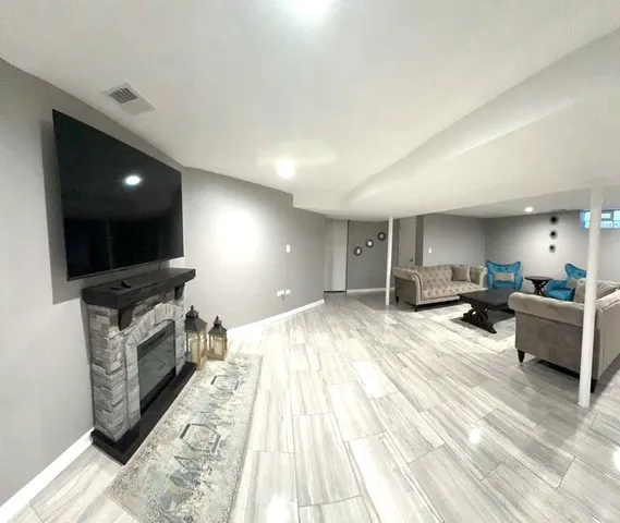 a large kitchen with stainless steel appliances kitchen island a large counter top a stove and a sink