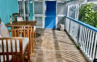 a view of a porch with a table and chairs