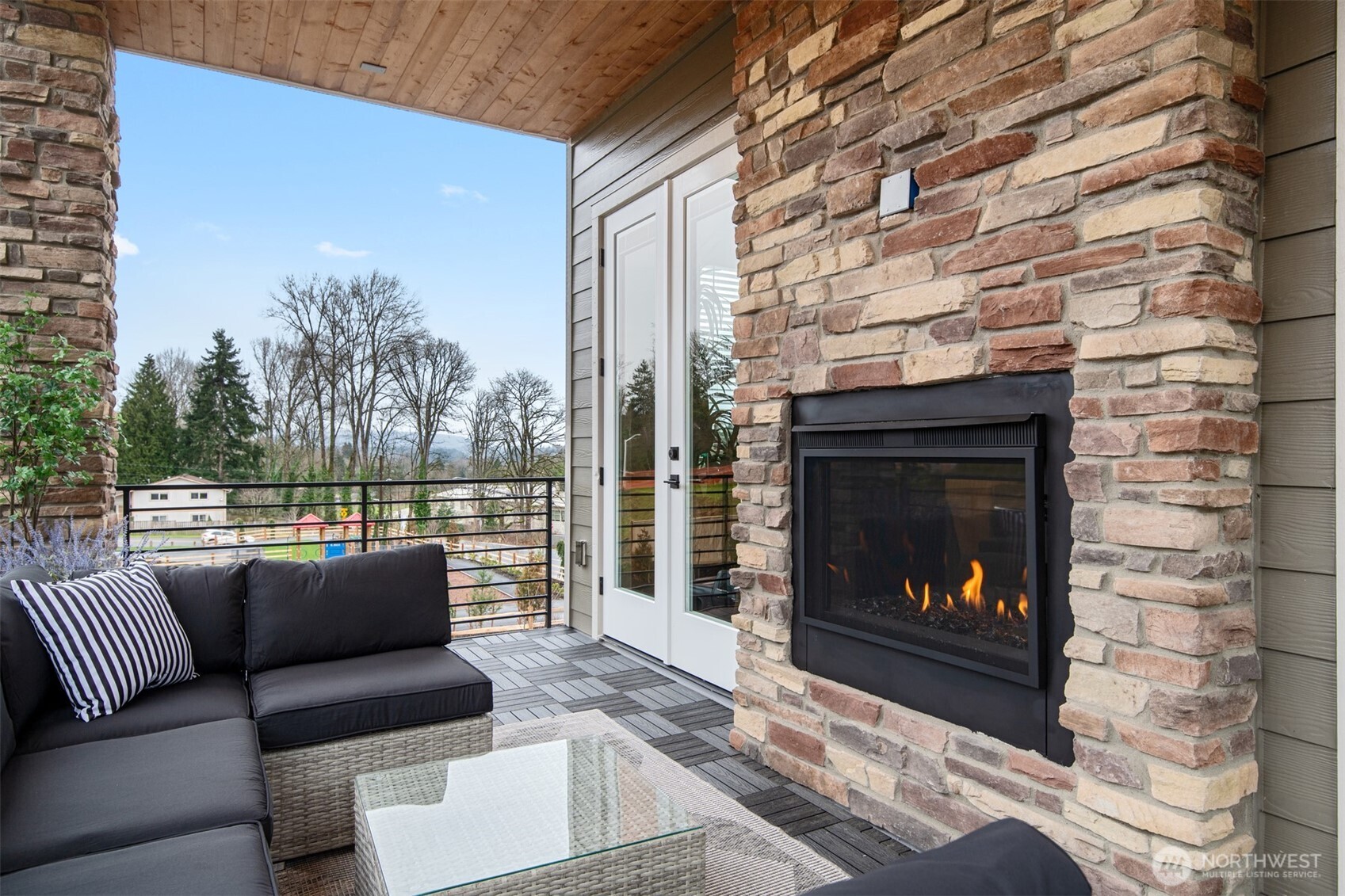 13031 75th Place South Seattle, WA 98178 - Photo 2 of 24 a living room with furniture a fireplace and a floor to ceiling window