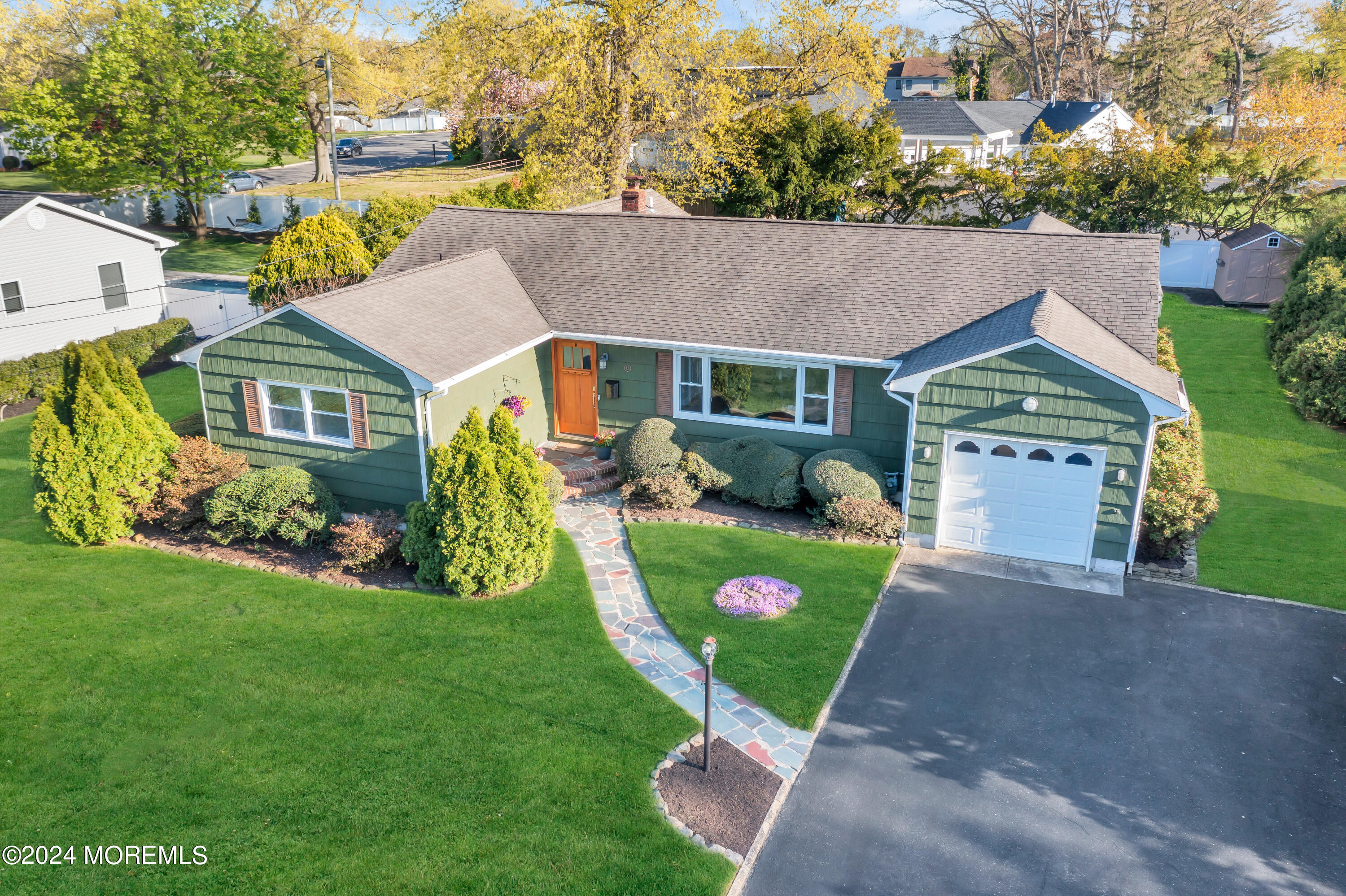 a aerial view of a house with a yard and plants