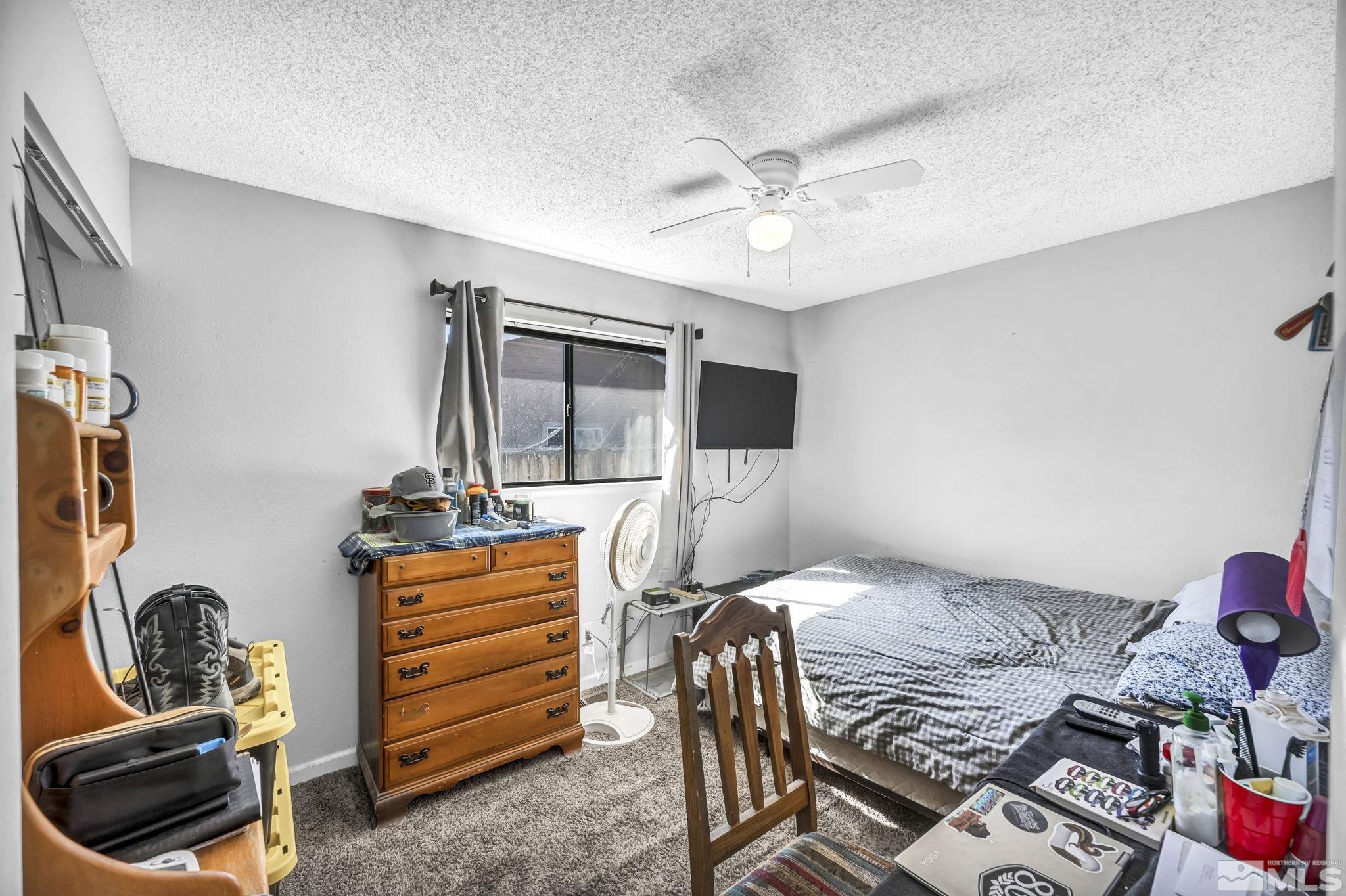 1011 Bonnie Lane Fallon, NV 89406 - Photo 19 of 31 a bedroom with a bed and wooden floor