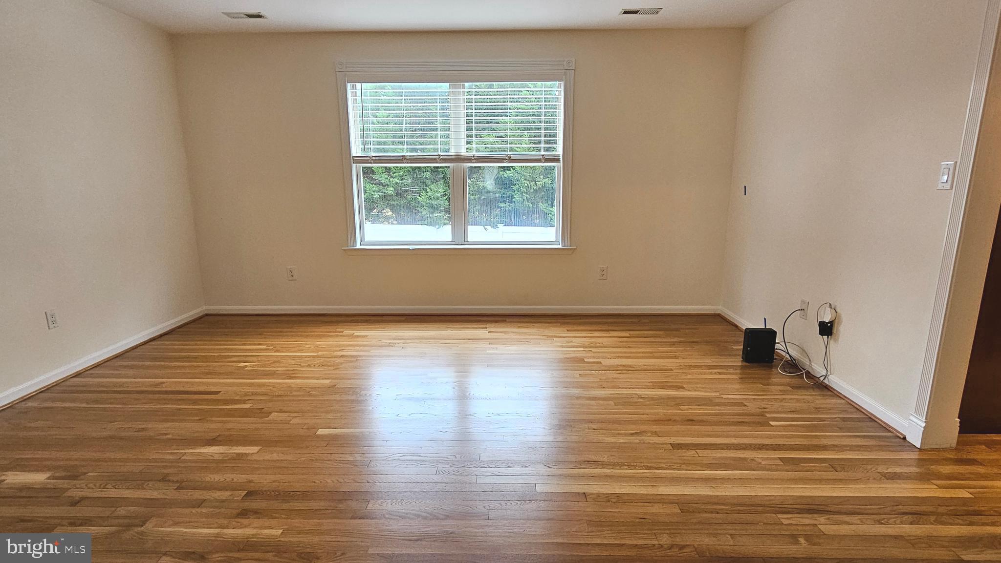 45655 Centerview Lane Great Mills, MD 20634 - Photo 13 of 38 a view of an empty room with wooden floor and a window