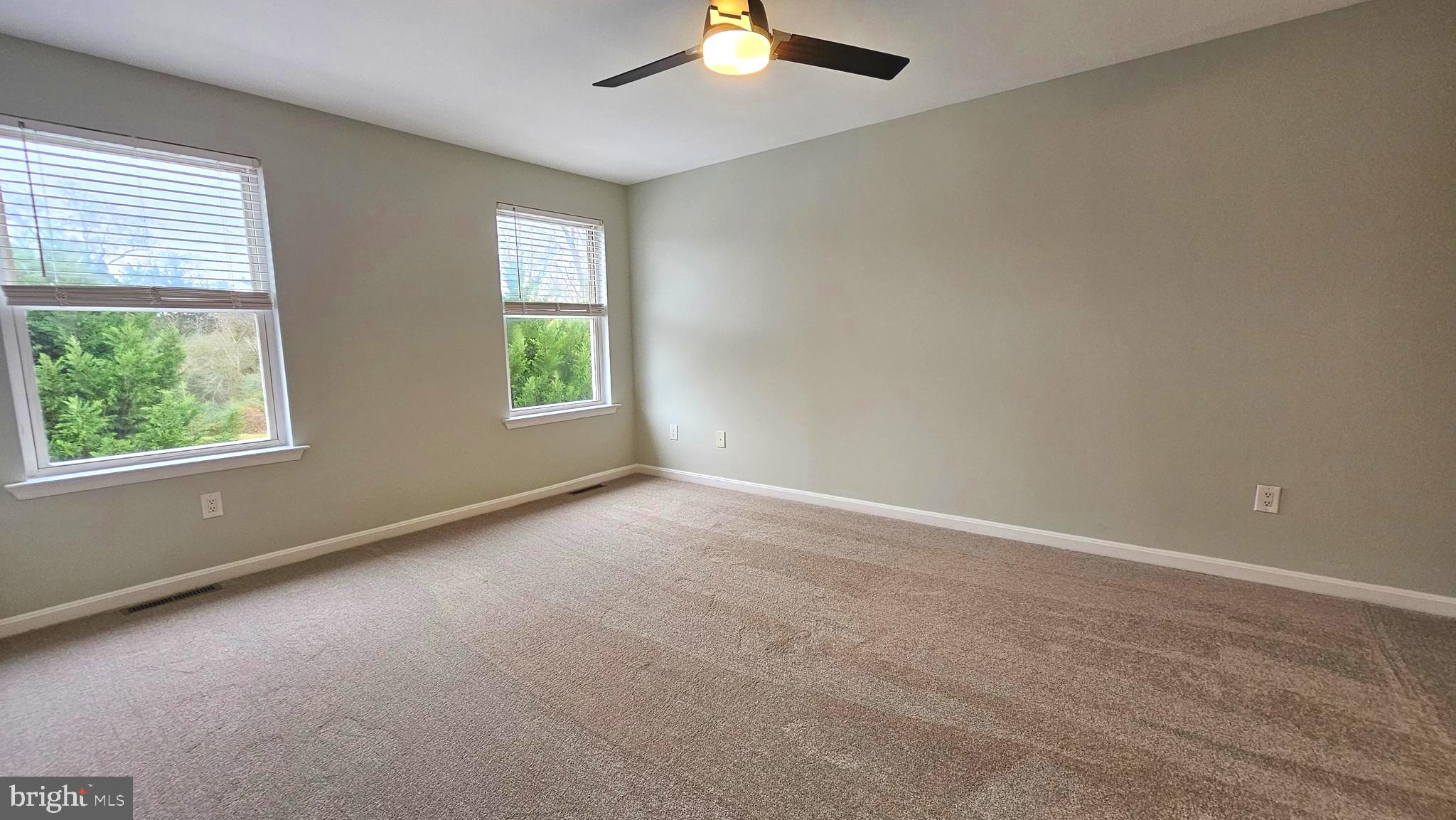 45655 Centerview Lane Great Mills, MD 20634 - Photo 17 of 38 an empty room with chandelier fan and windows