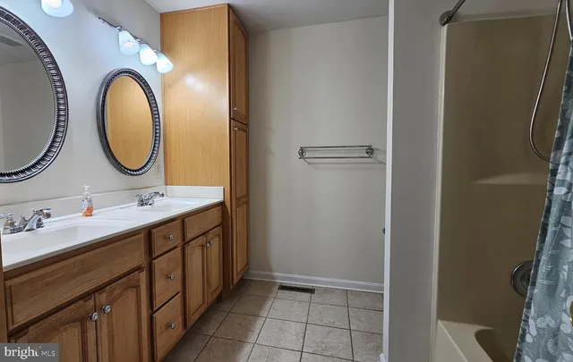 a bathroom with a double vanity sink and a mirror
