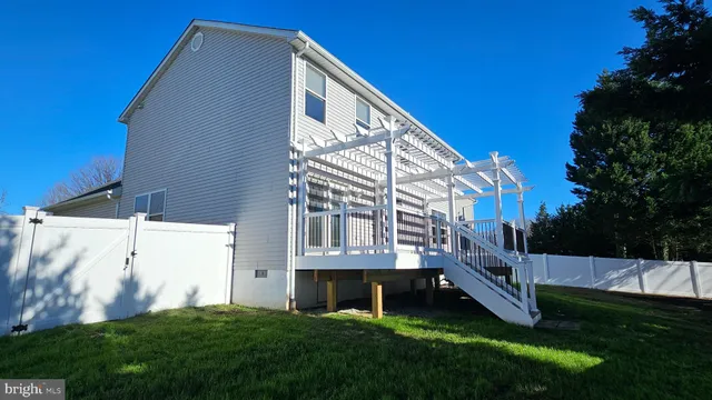 a view of backyard with barbeque grill and stairs