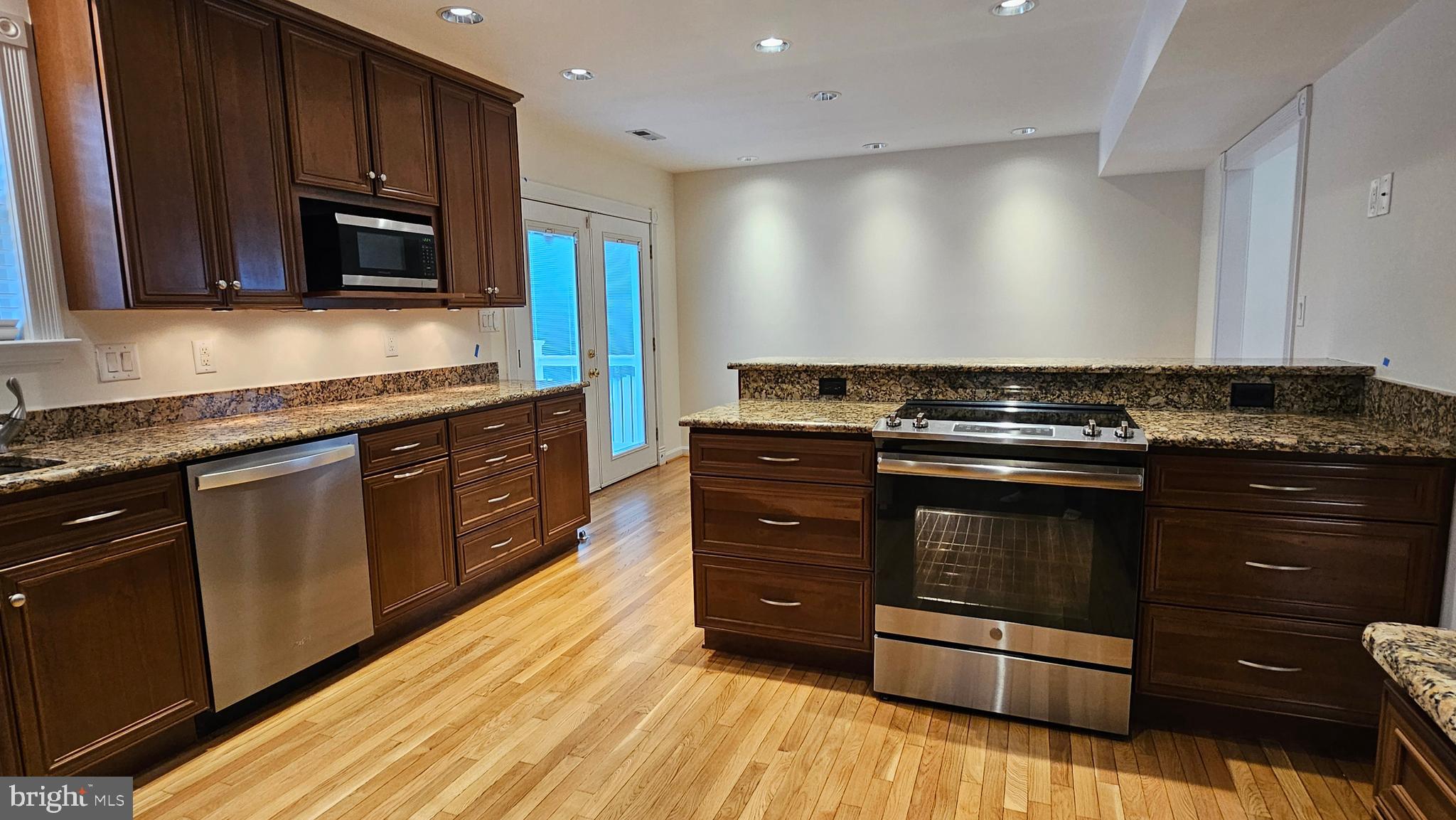 45655 Centerview Lane Great Mills, MD 20634 - Photo 6 of 38 a kitchen with stainless steel appliances granite countertop wooden cabinets and a stove top oven