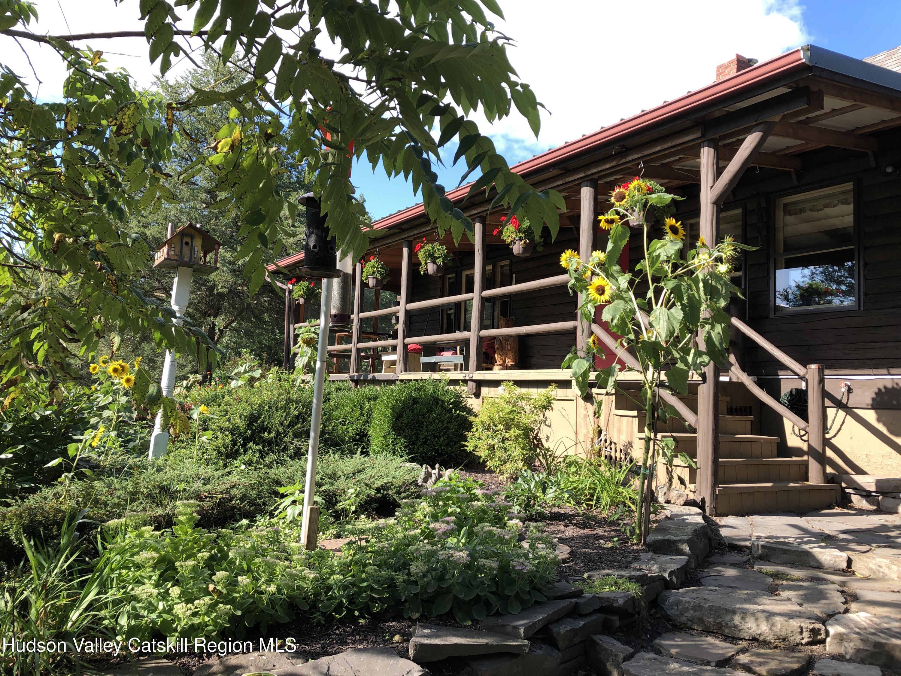 634 Old Plank Road Coxsackie, NY 12042 - Photo 3 of 49 a house with a tree in front of it