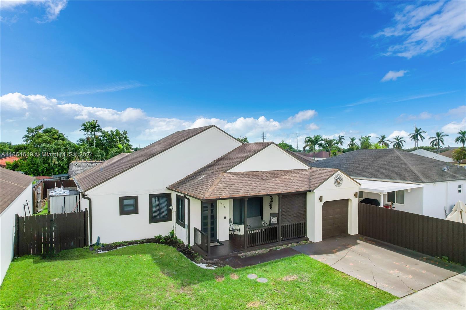 15831 Southwest 143rd Court Miami, FL 33177 - Photo 1 of 27 a front view of a house with a yard