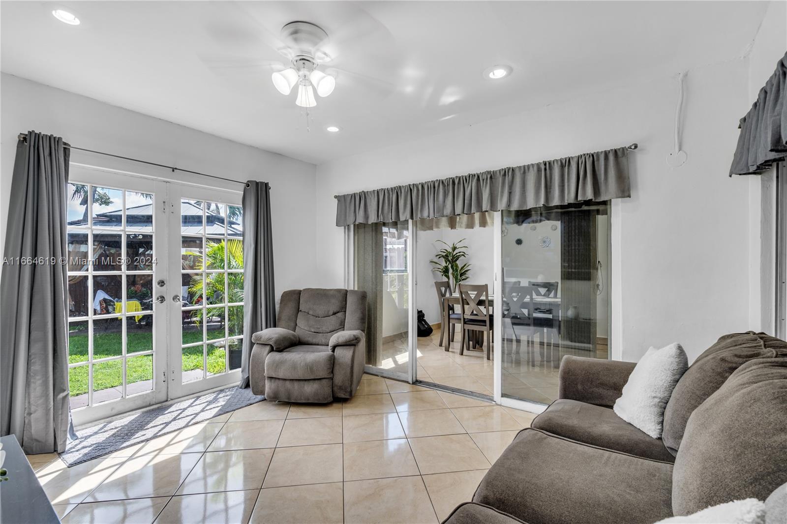 15831 Southwest 143rd Court Miami, FL 33177 - Photo 14 of 27 a living room with furniture and a large window