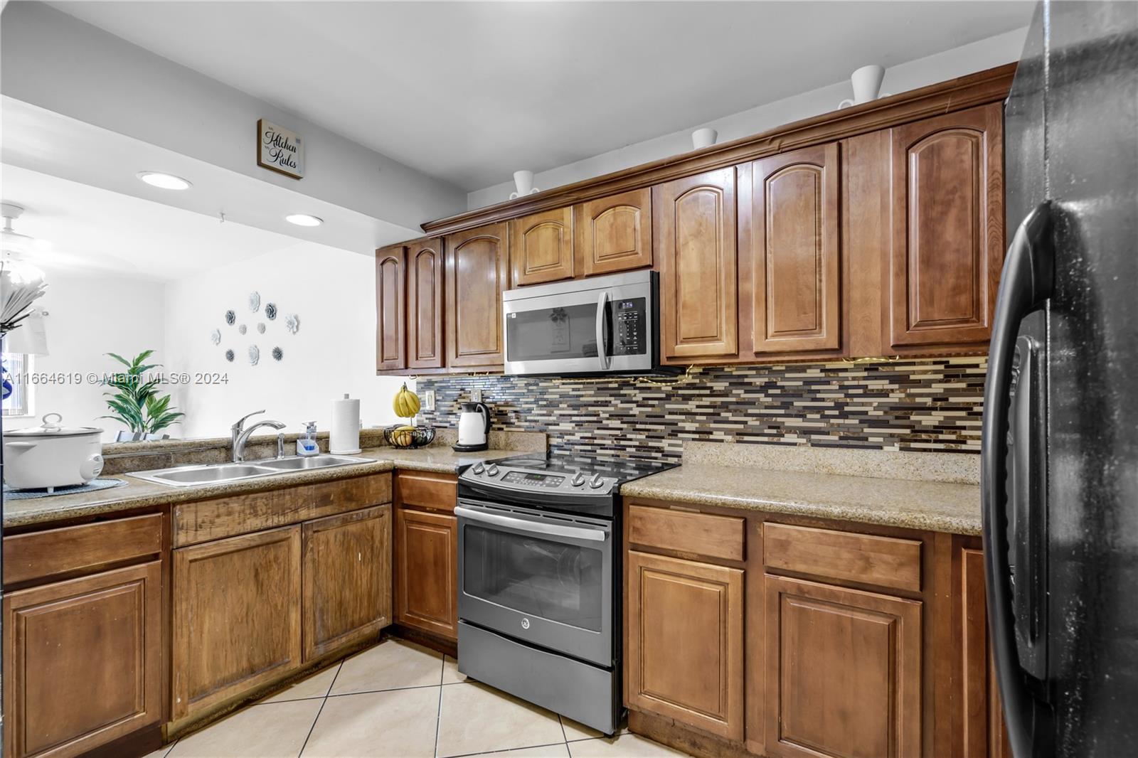 15831 Southwest 143rd Court Miami, FL 33177 - Photo 15 of 27 a kitchen with stainless steel appliances granite countertop a sink stove and refrigerator