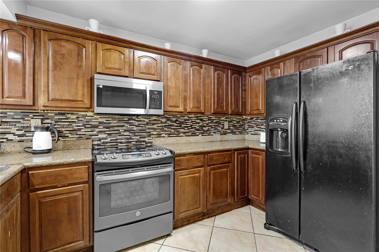 15831 Southwest 143rd Court Miami, FL 33177 - Photo 16 of 27 a kitchen with stainless steel appliances granite countertop a refrigerator stove and sink