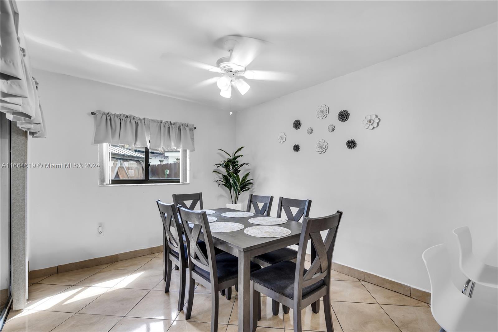 15831 Southwest 143rd Court Miami, FL 33177 - Photo 17 of 27 a dining room with furniture and chandelier