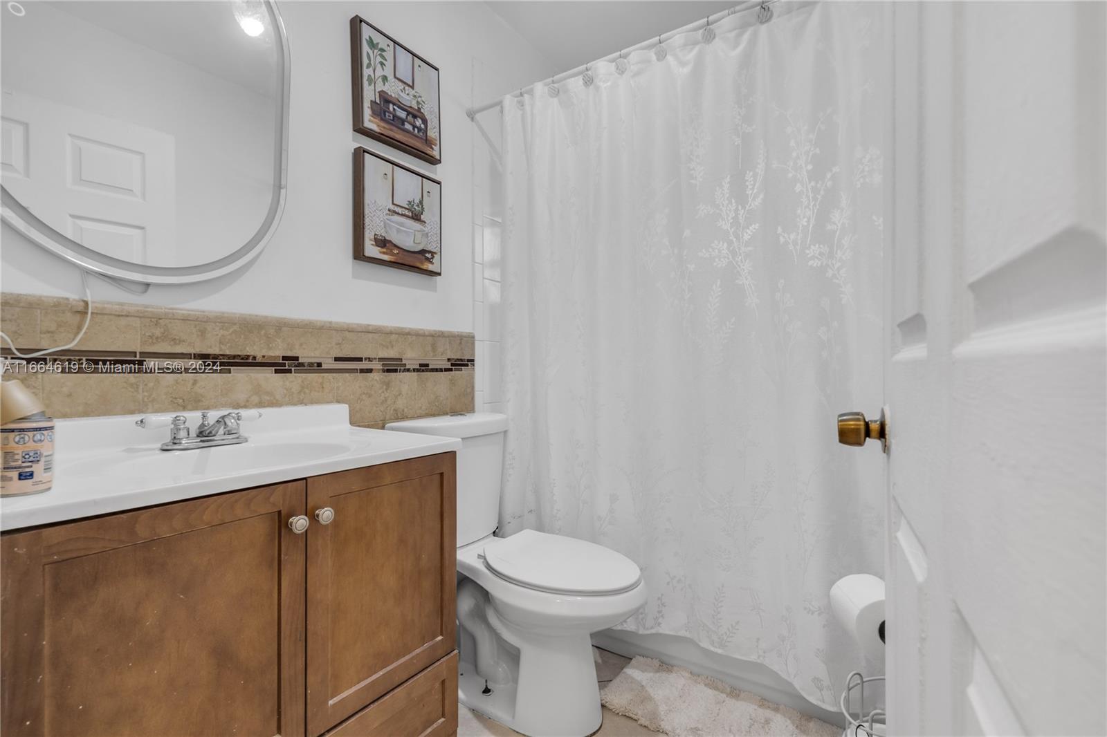 15831 Southwest 143rd Court Miami, FL 33177 - Photo 18 of 27 a bathroom with a sink a toilet and a mirror