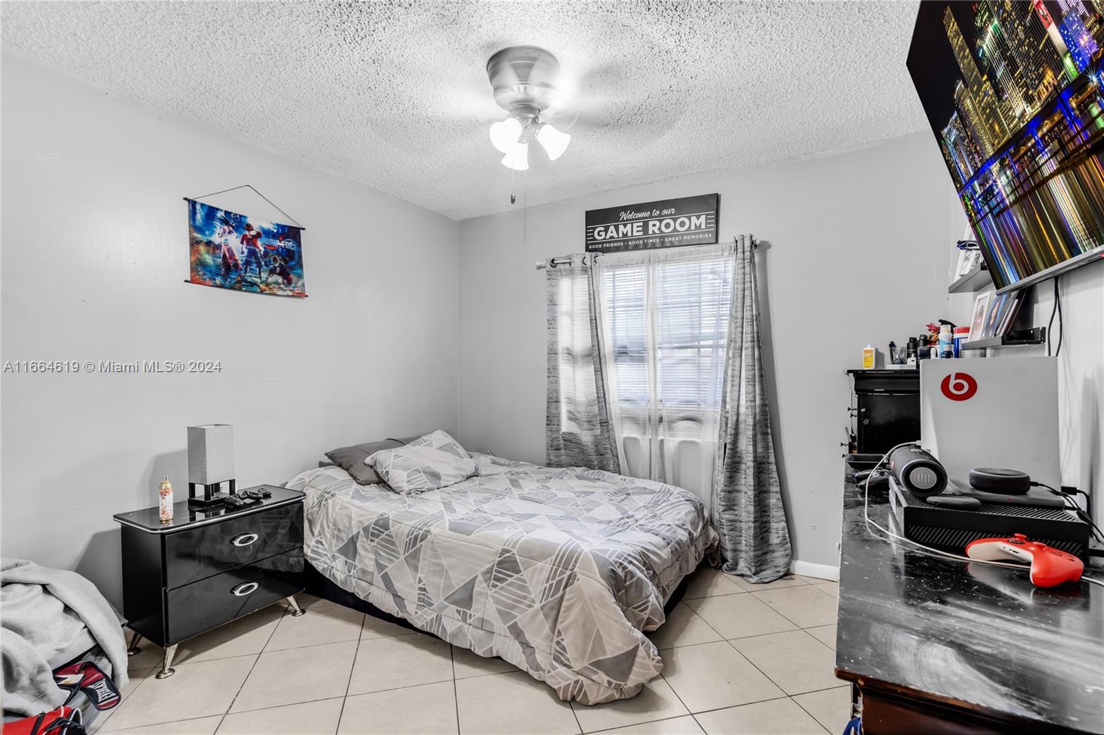15831 Southwest 143rd Court Miami, FL 33177 - Photo 21 of 27 a bedroom with a bed and a tv