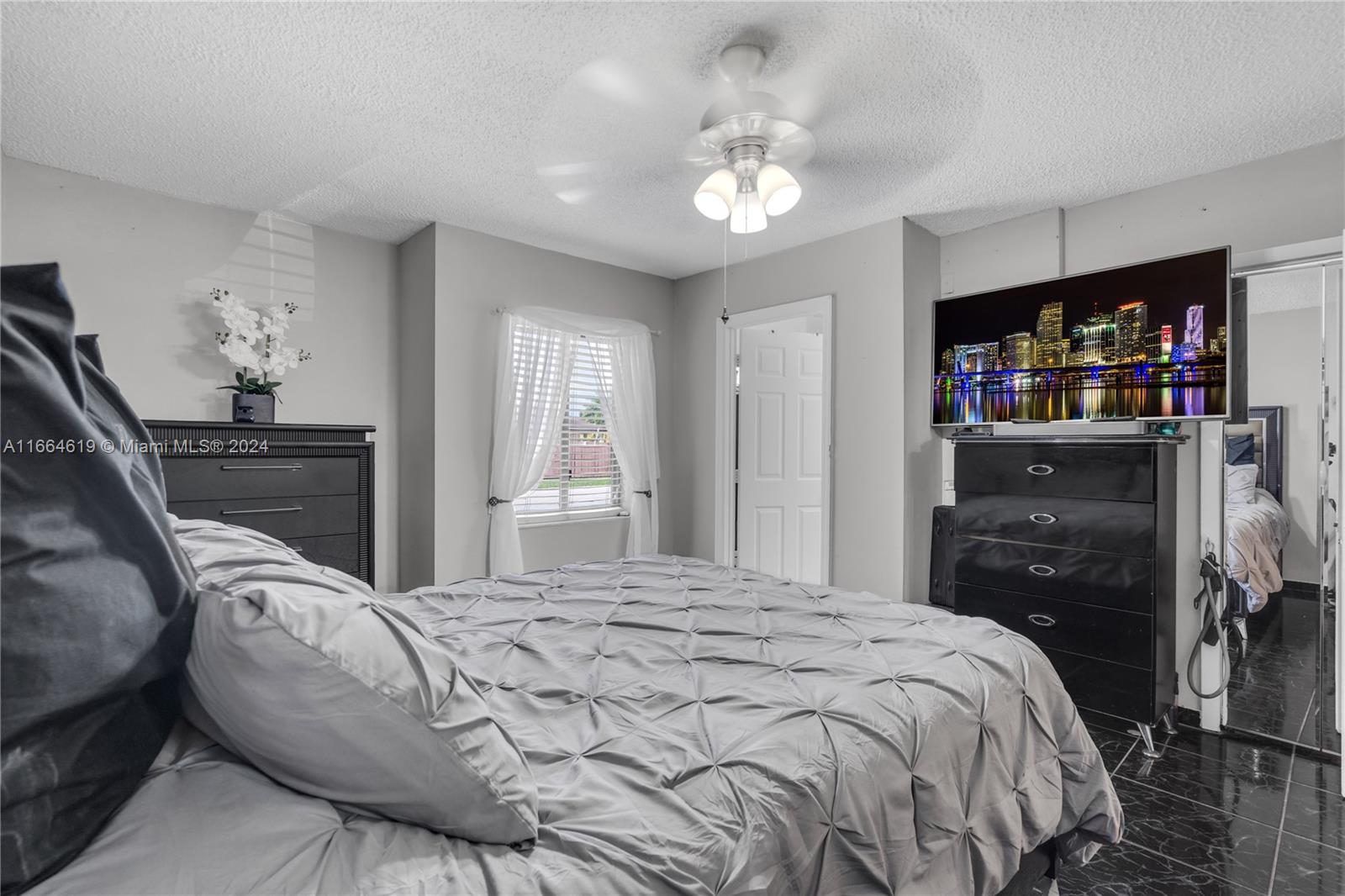 15831 Southwest 143rd Court Miami, FL 33177 - Photo 22 of 27 a bedroom with a bed and a television