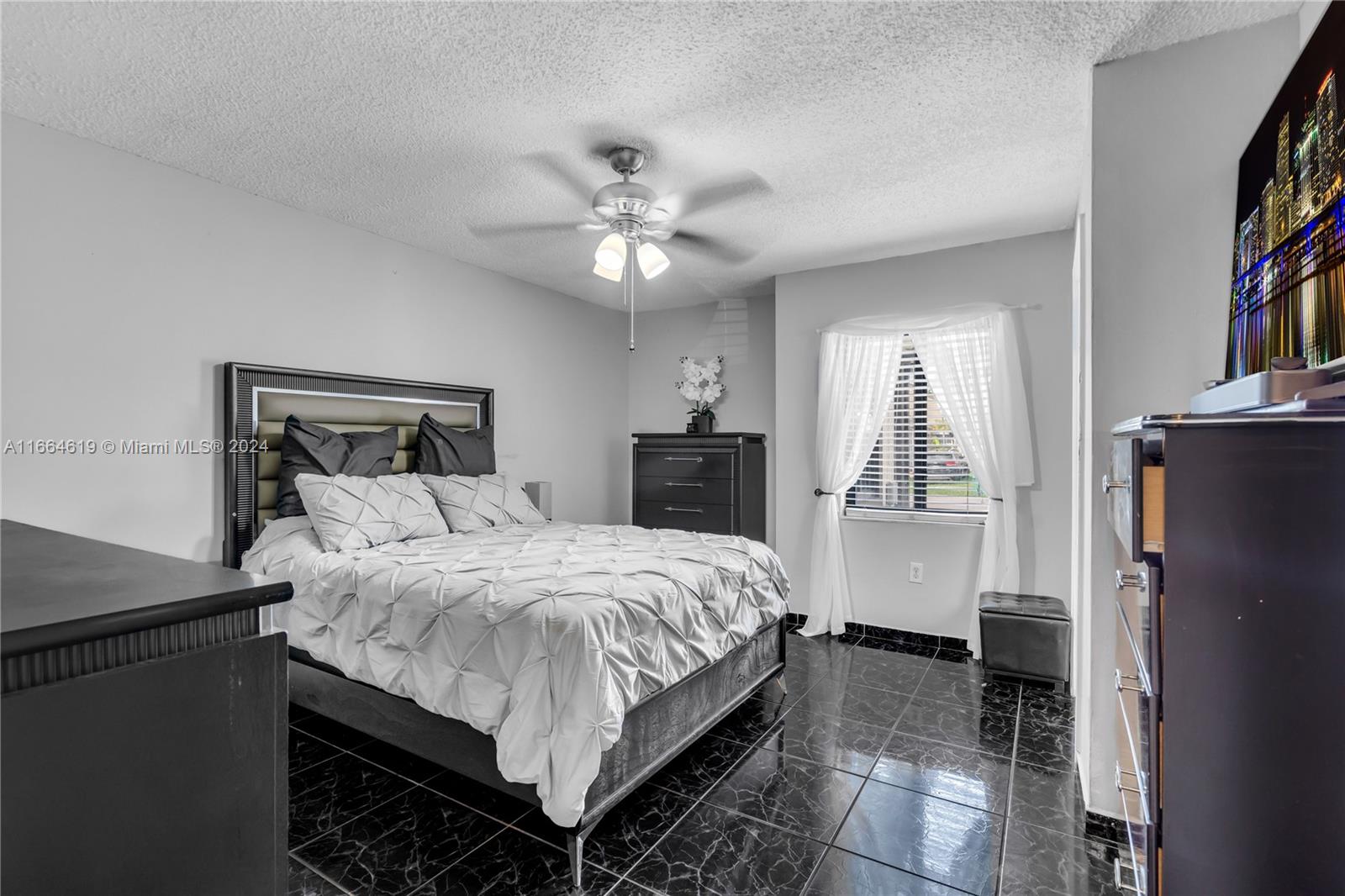 15831 Southwest 143rd Court Miami, FL 33177 - Photo 23 of 27 a bedroom with a bed and a chandelier