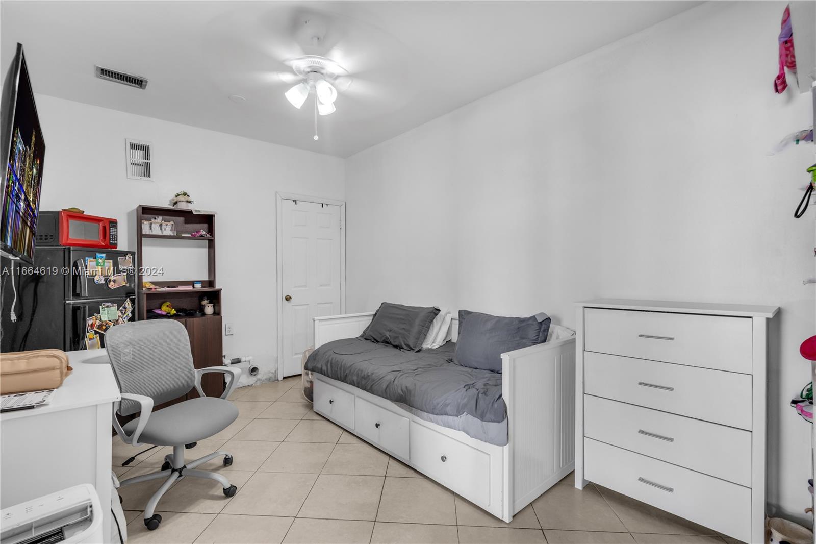 15831 Southwest 143rd Court Miami, FL 33177 - Photo 25 of 27 a living room with furniture and a flat screen tv