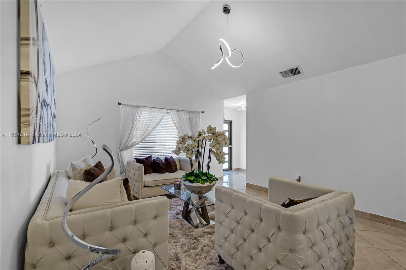 15831 Southwest 143rd Court Miami, FL 33177 - Photo 10 of 27 a living room with furniture and a potted plant