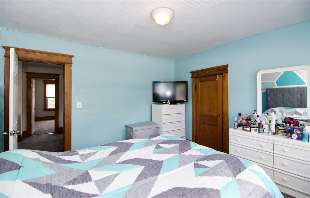 16 Amity Court Springfield, MA 01108 - Photo 29 of 42 a bedroom with a bed and flat screen tv