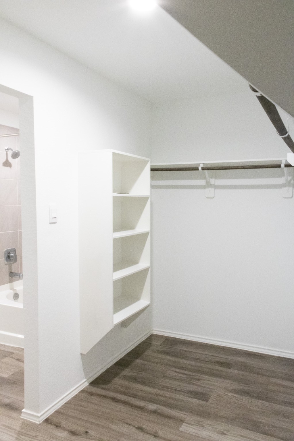 5342 Pinecliff Grove Court Spring, TX 77373 - Photo 12 of 27 a view of an empty walk in closet with wooden floor