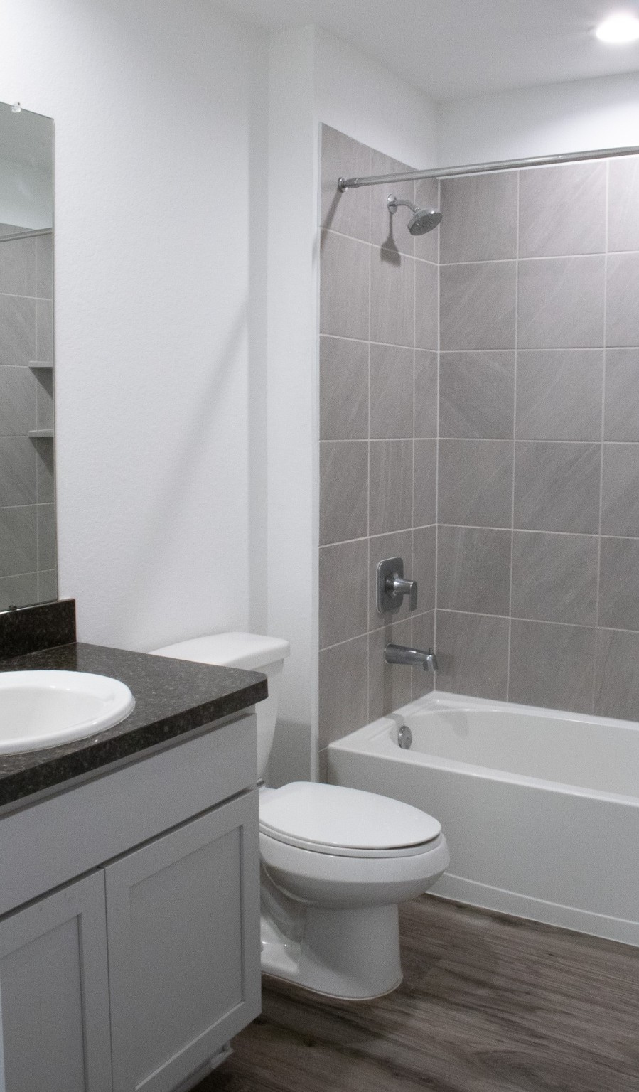 5342 Pinecliff Grove Court Spring, TX 77373 - Photo 14 of 27 a bathroom with a granite countertop toilet a sink and a bathtub