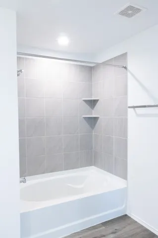 a bathroom with a shower and a bathtub