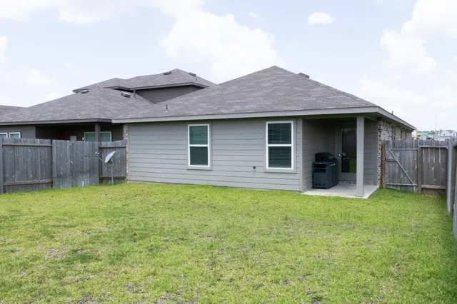a backyard of a house with table and chairs