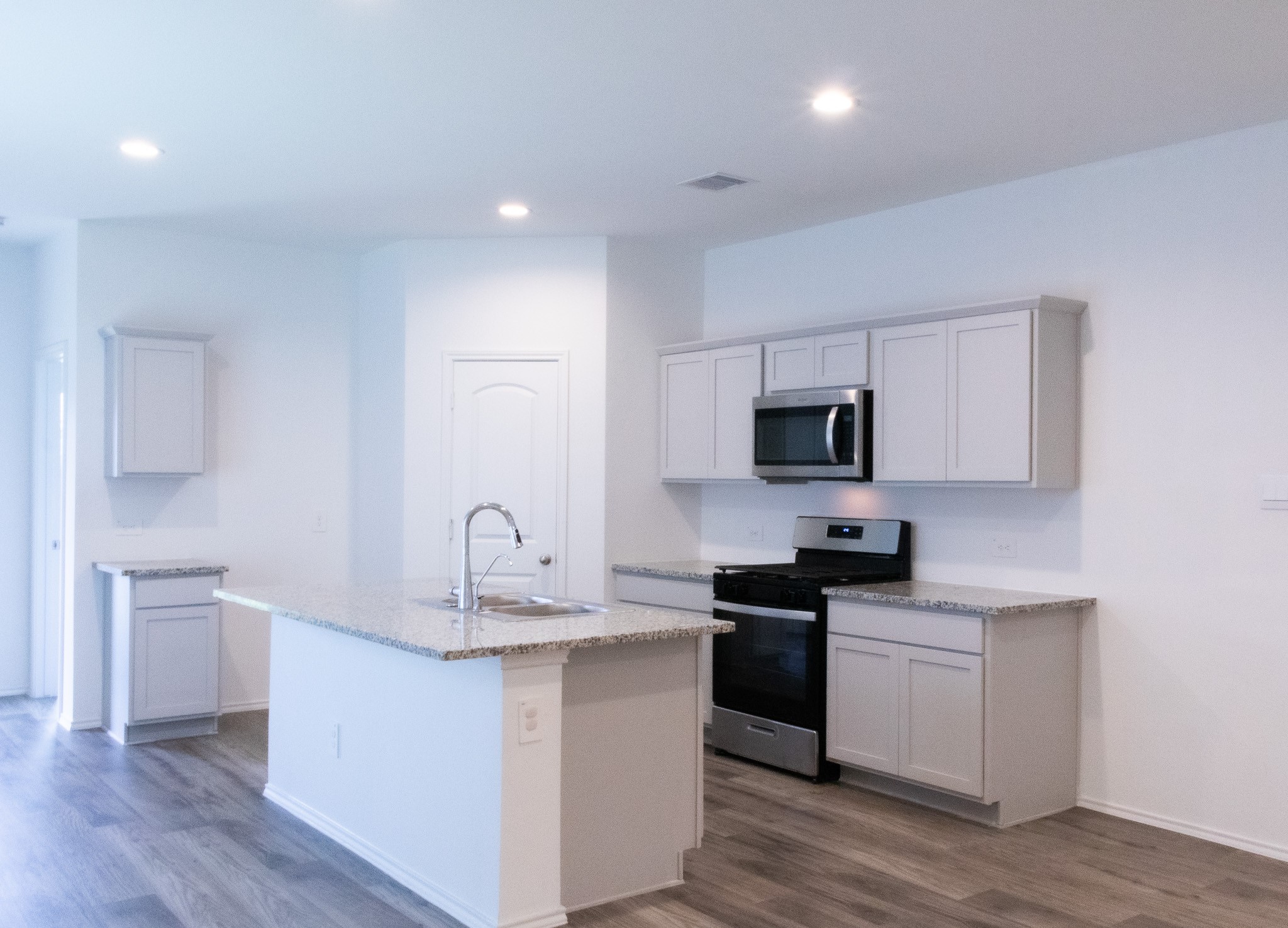5342 Pinecliff Grove Court Spring, TX 77373 - Photo 7 of 27 a kitchen with granite countertop a sink and a stove top oven