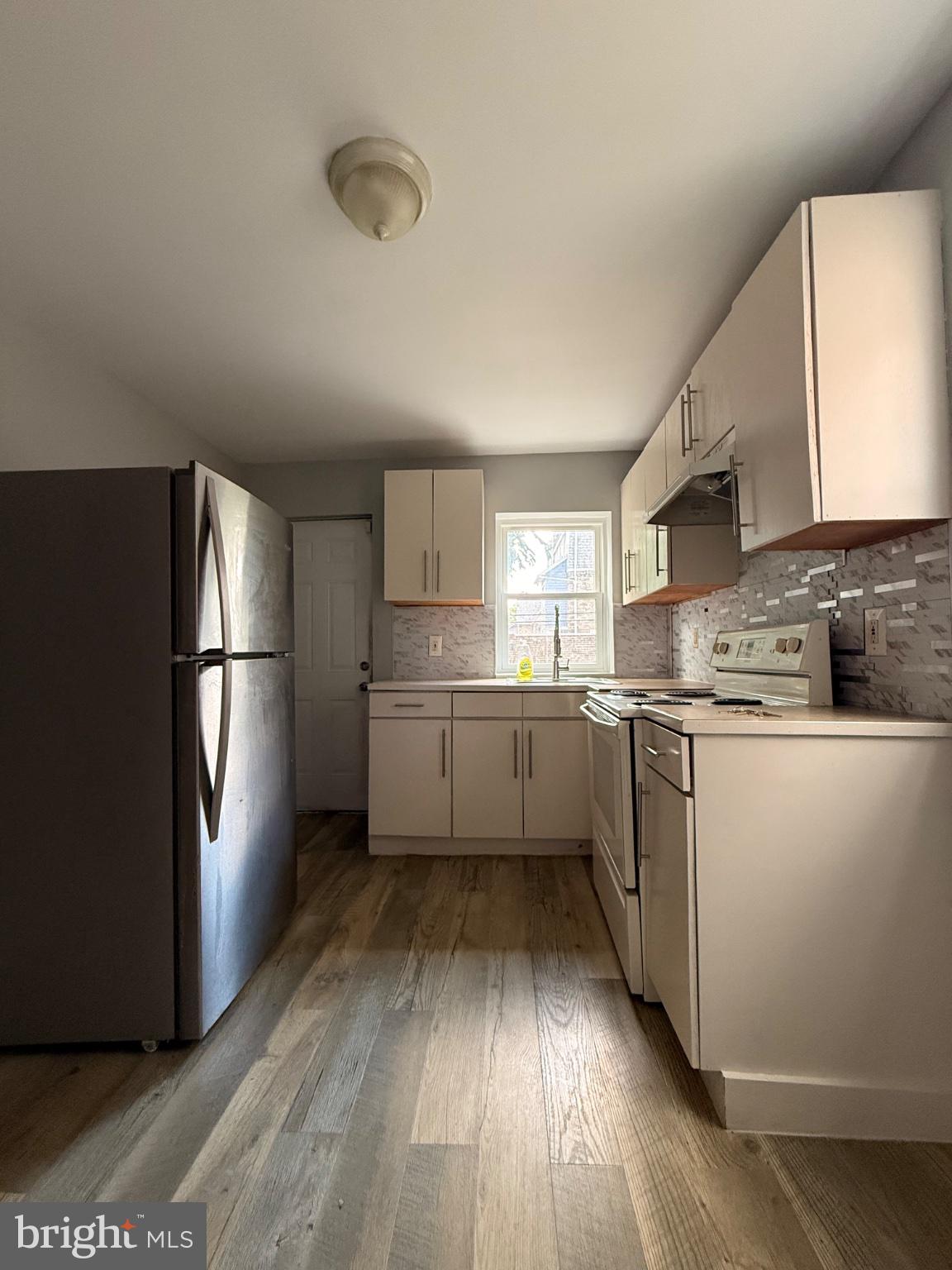822 Wynnewood Road, Unit 1 Philadelphia, PA 19151 - Photo 14 of 16 a kitchen with stainless steel appliances a refrigerator sink and cabinets