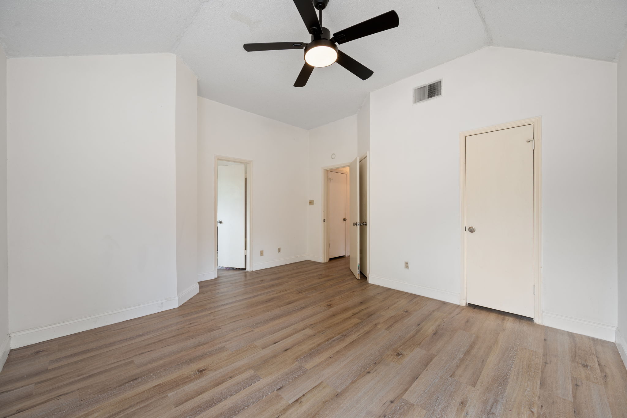 12501 Fallen Tower Lane Austin, TX 78753 - Photo 20 of 31 an empty room with wooden floor ceiling fan and windows