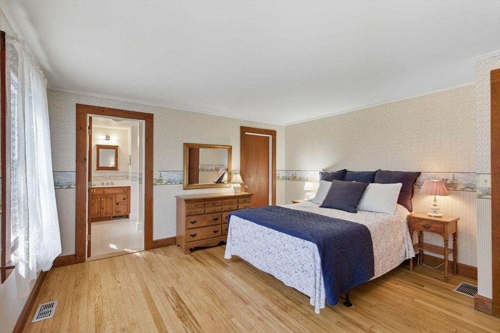 6 Defiance Lane Orleans, MA 02653 - Photo 11 of 27 a bedroom with a large bed and a dresser