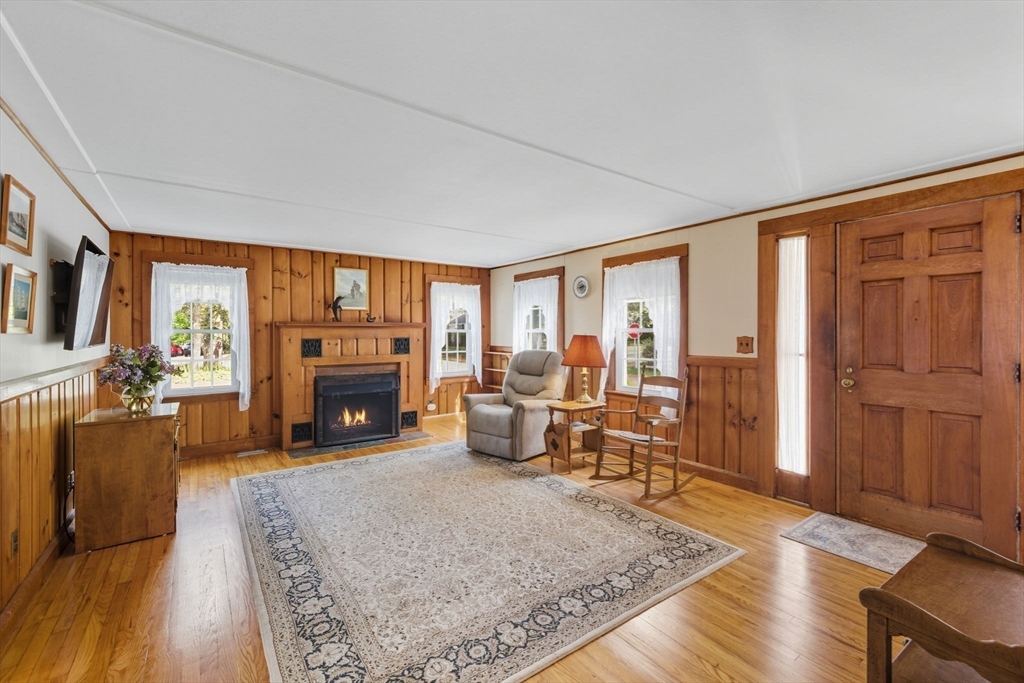 6 Defiance Lane Orleans, MA 02653 - Photo 2 of 27 a living room with furniture large window and a fireplace