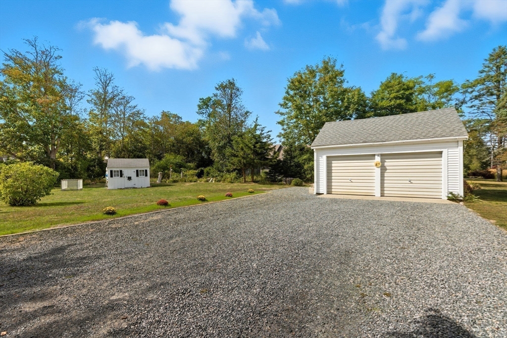 6 Defiance Lane Orleans, MA 02653 - Photo 21 of 27 a view of a house with a yard and a large tree