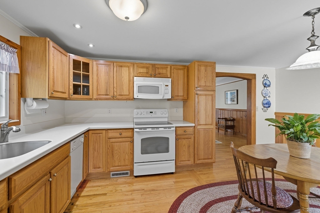 6 Defiance Lane Orleans, MA 02653 - Photo 7 of 27 a kitchen with stainless steel appliances granite countertop a stove a sink and a microwave