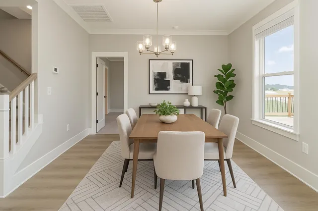 a view of a dining room with furniture window and wooden floor