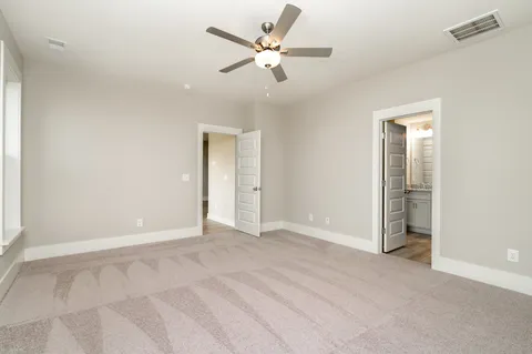 an empty room with fan and a ceiling fan