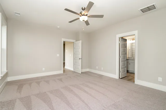 an empty room with fan and a ceiling fan