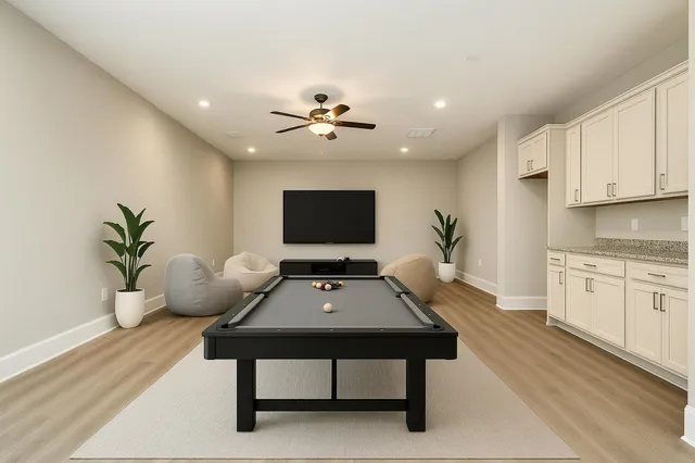 a living room with furniture potted plant and a flat screen tv